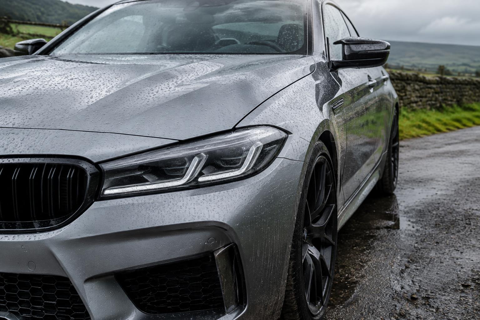 Rain beading across the paint of a ceramic coated silver car